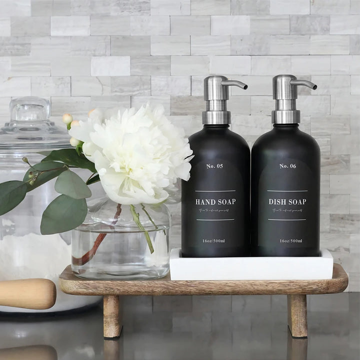 Waterproof bathroom dispenser labels on bottles